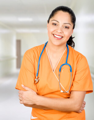 Smiling female doctor standing with arms crossed