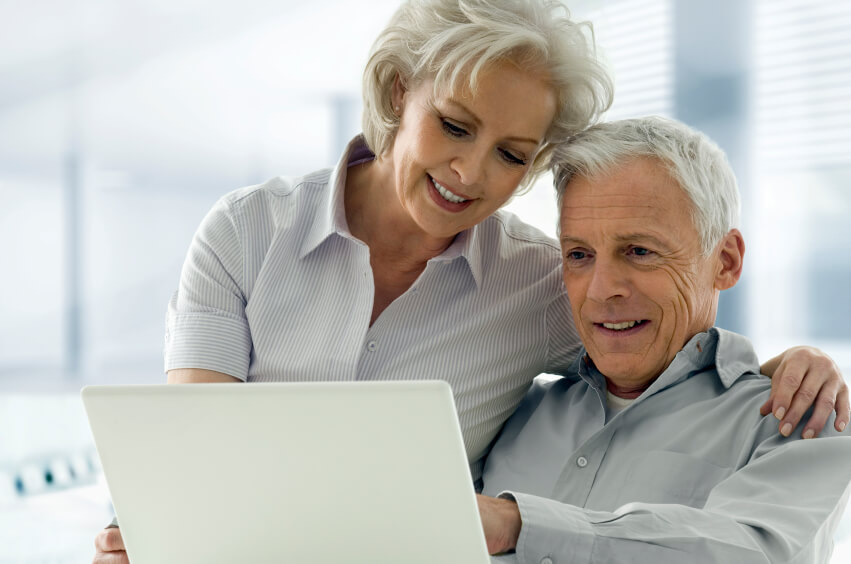 Middle-aged couple looking at a laptop screen